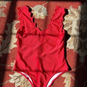 Size 12 one piece. Would make a cute bodysuit top also. Never worn!